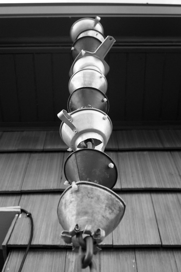 DIY rain chain made from funnels. Not only make a good sound and enhance your house exterior appearance, but also divert water away from your house. 