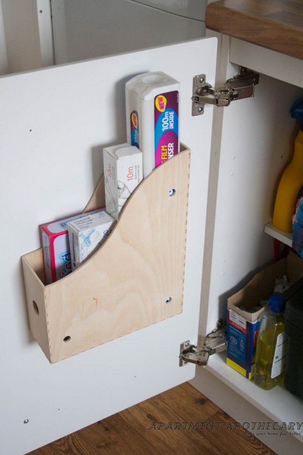 Screwing a magazine file holder to the inside of kitchen cupboards adds space to store more bulky items like chopping boards, cleaning products etc.