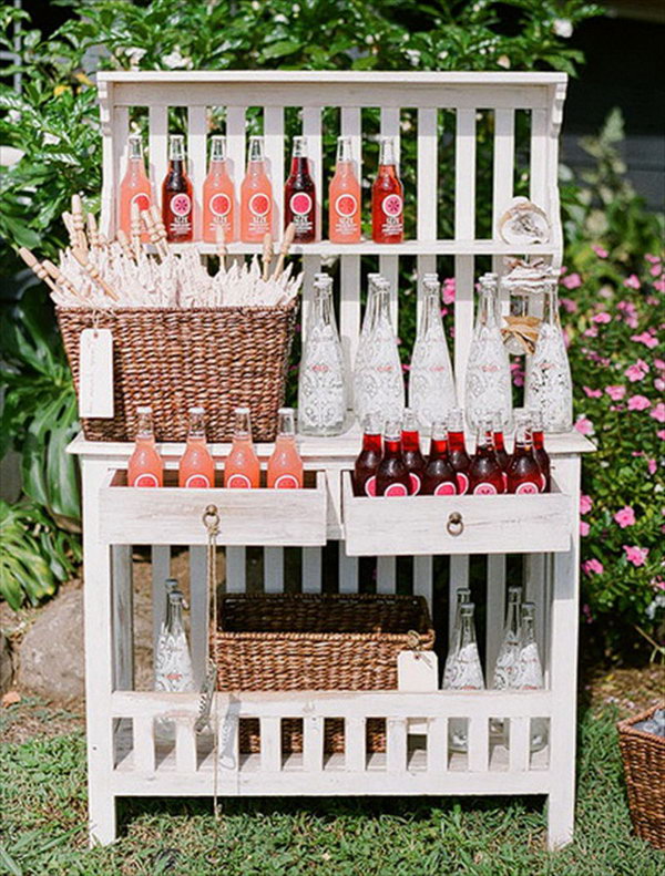 Bookshelf Drink Station. Serve your beverages in adorable glass bottles. Display them in good order in the bookshelf. This works perfect for a rustic style.