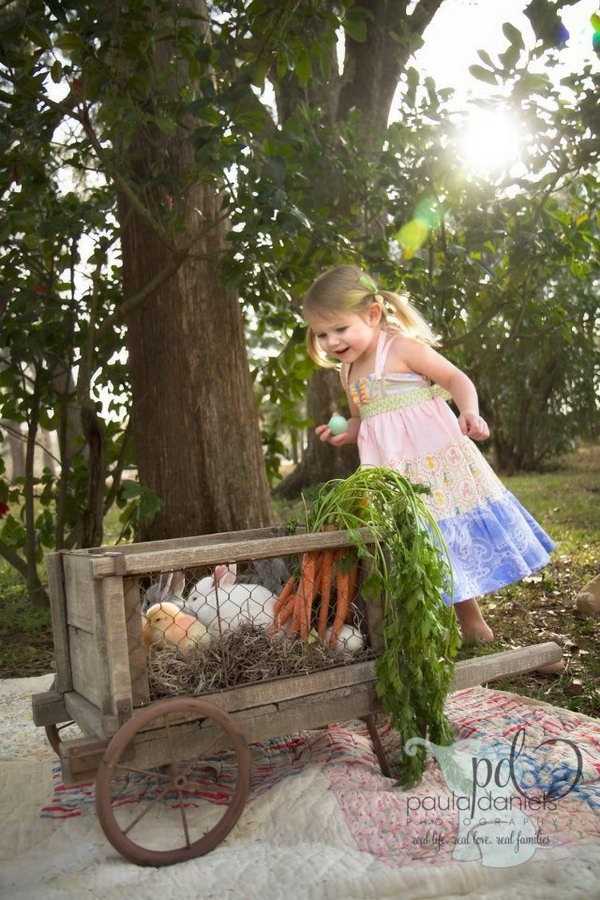 Easter Photo Bunny Cart. I have never seen such a bunny cart before. The little girl in this picture holding an Easter egg must be curious about the bunny cart too. She is gazing at it. 