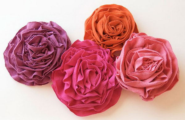 DIY Flouncy T Shirt Flowers. It's hard to believe that these giant,lovely  blooms are made from the discarded old T shirt. They are certain to brighten any day if you  make a vase for them.