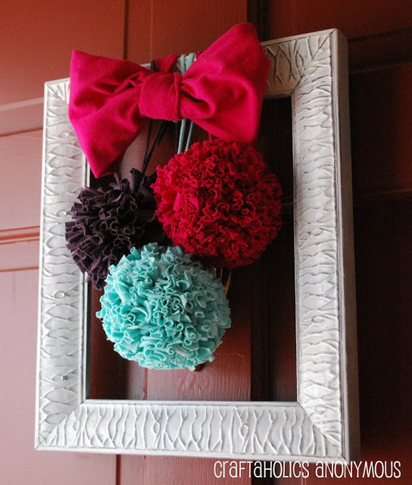 DIY T shirt Pom Poms. T shirt pom poms are so much more durable than tissue paper to hang on the door. They are so whimsical and fun and also great for adding color to any room. You can make some in different colors with the tutorials below.