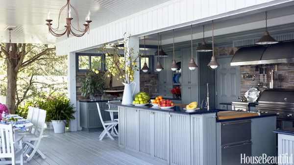 Plain and fancy cabinets with Nantucket style doors and blue toned Caesar stone on top plus the colors of water. It is a great place for cooking and holding a party during summer.