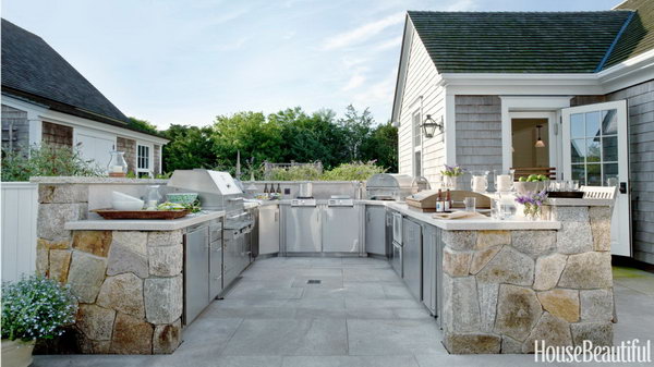 The U shaped layout of this Nantucket kitchen is zoned from hot to cold. All of the appliances and the stainless steel cabinetry are designed to be weather tight.