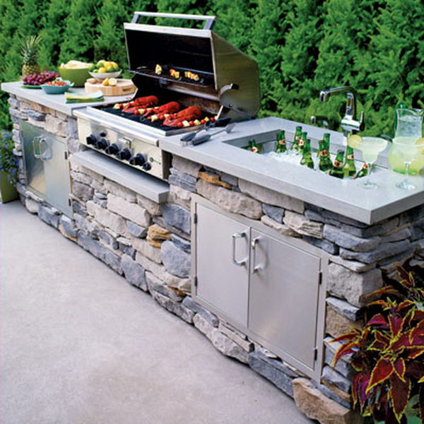 A stone kitchen can be both functional and pretty. It is really a great place for a summer party with an amazing oven and a beer cooling poor.