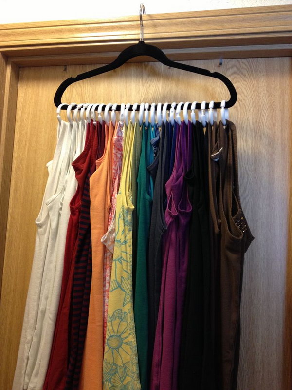 Tank Top Clothes Hanger. With just a few shower curtains rings and a velvet hanger, you can store those bad boys all on ONE hanger.