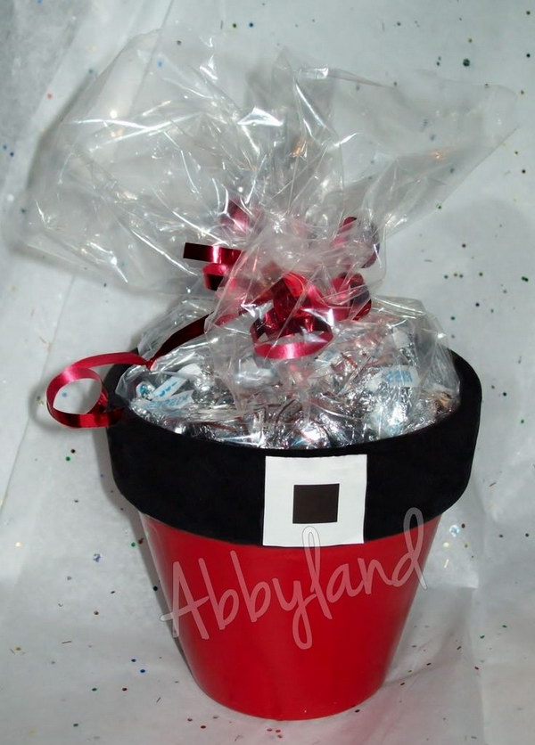 DIY Santa Flower Pots Filled with Hugs and Kisses. A DIY Flower pot is a great personalized gift or a wonderful addition to the garden. So it's a great idea to make inexpensive and whimsical flower pots decorated as Santa's belly for your neighbors to add a festive touch.