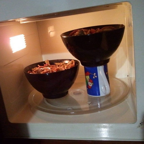 Double Microwave Capacity. Use vertical space and heat 2 dishes at the same time. This microwave life hack is a great idea.