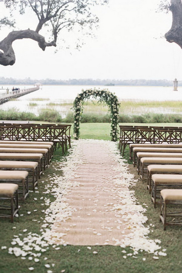 Classic Floral Arch with Petal Burlap Wedding Aisle Runner
 and Linen Upholstered Wooden Benches 
