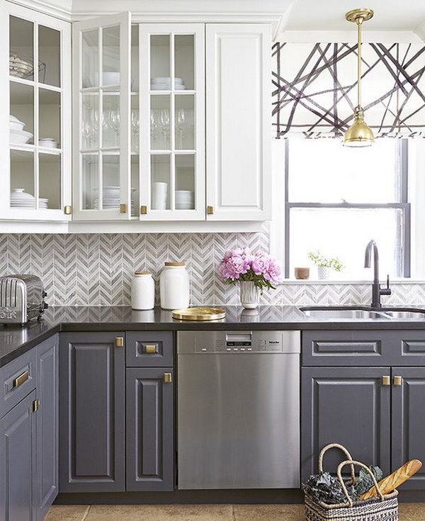 Grey and White Chevron Tile Backsplash in a Stylish Kitchen with Contrasting Cabinets