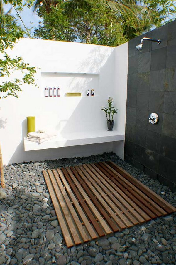 Natural Cobbles Covered Outdoor Shower Area with Wall Mounted Bench.