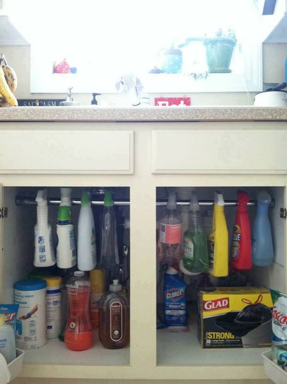 Hang Cleaning Products Under The Sink With a Tension Rod.
