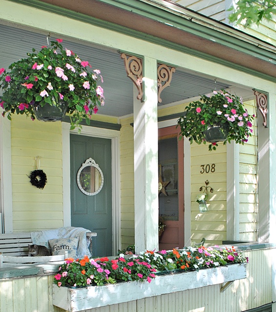 Create an Inviting Front Porch with Hanging Baskets and Flower Boxes.