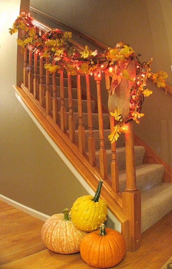 Staircase Decorated With Fall Garlands And String Lights.