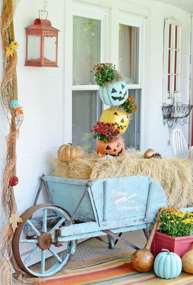 Aqua Painted Wheelbarrow With Topsy Turvy Stacked Pumpkins In.