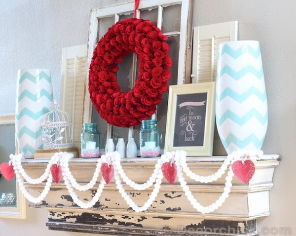 White Pom Pom Garlands And Red Rose Wreath With A Pop Of Turquoise.