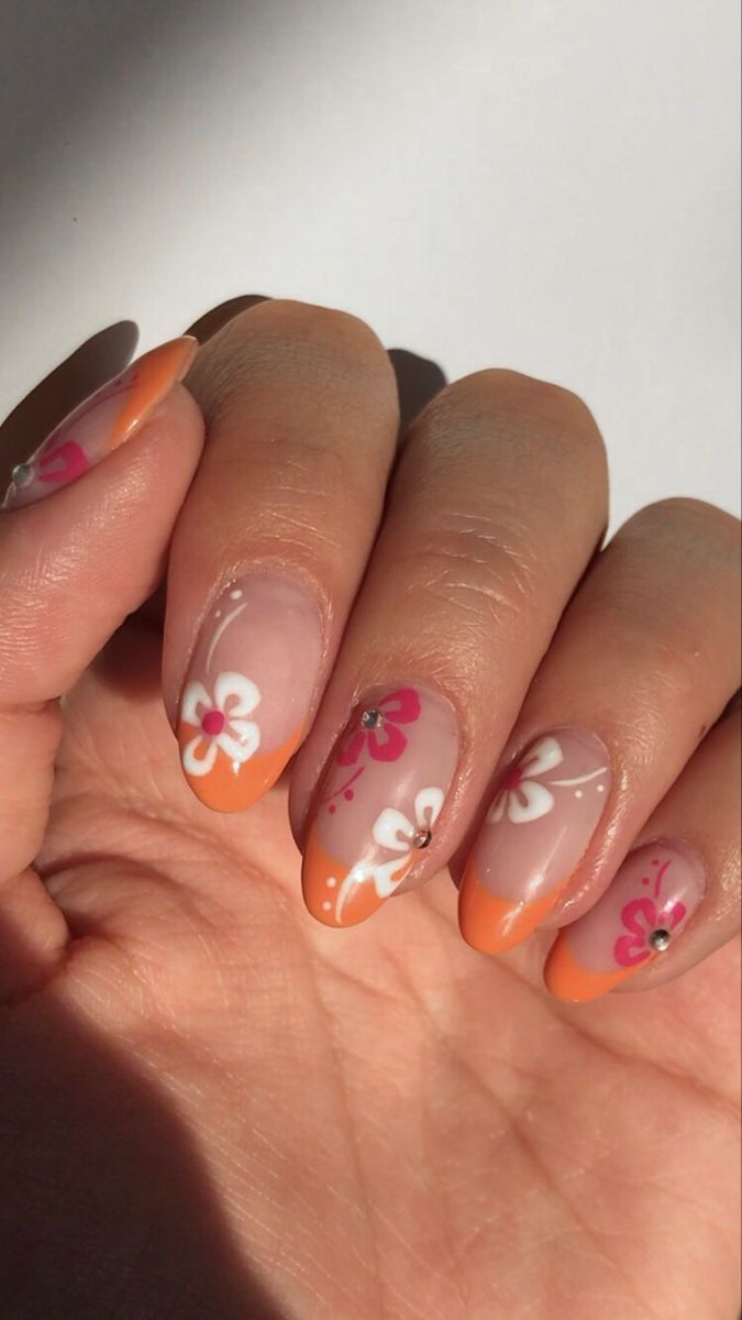 Clear Nails with Flowers and Orange Tips.
